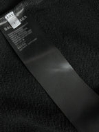 Balenciaga inner neck label on black fabric, with care and product text