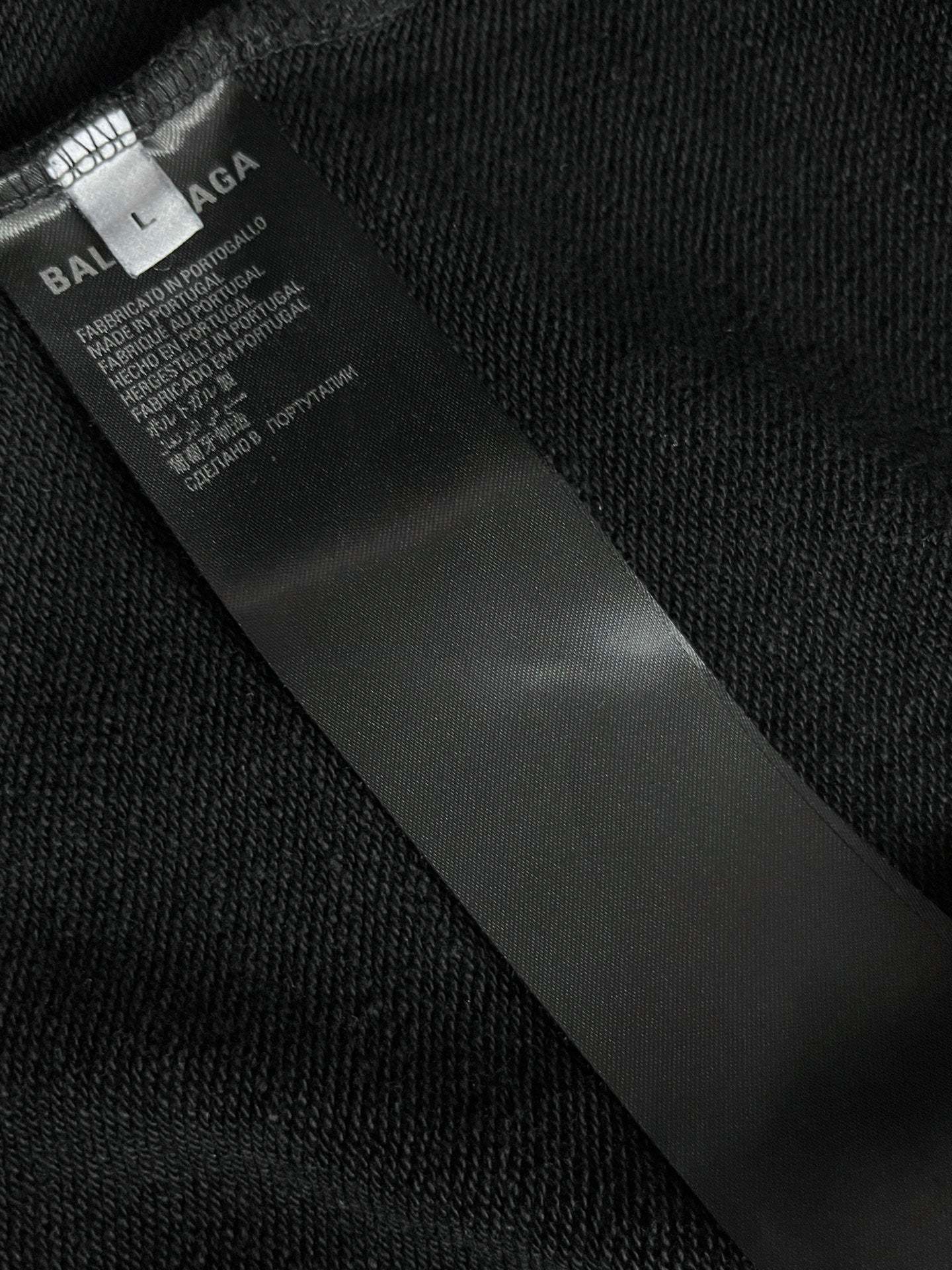 Balenciaga inner neck label on black fabric, with care and product text