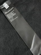 Balenciaga size label on inner neck of hoodie, black fabric tag close-up