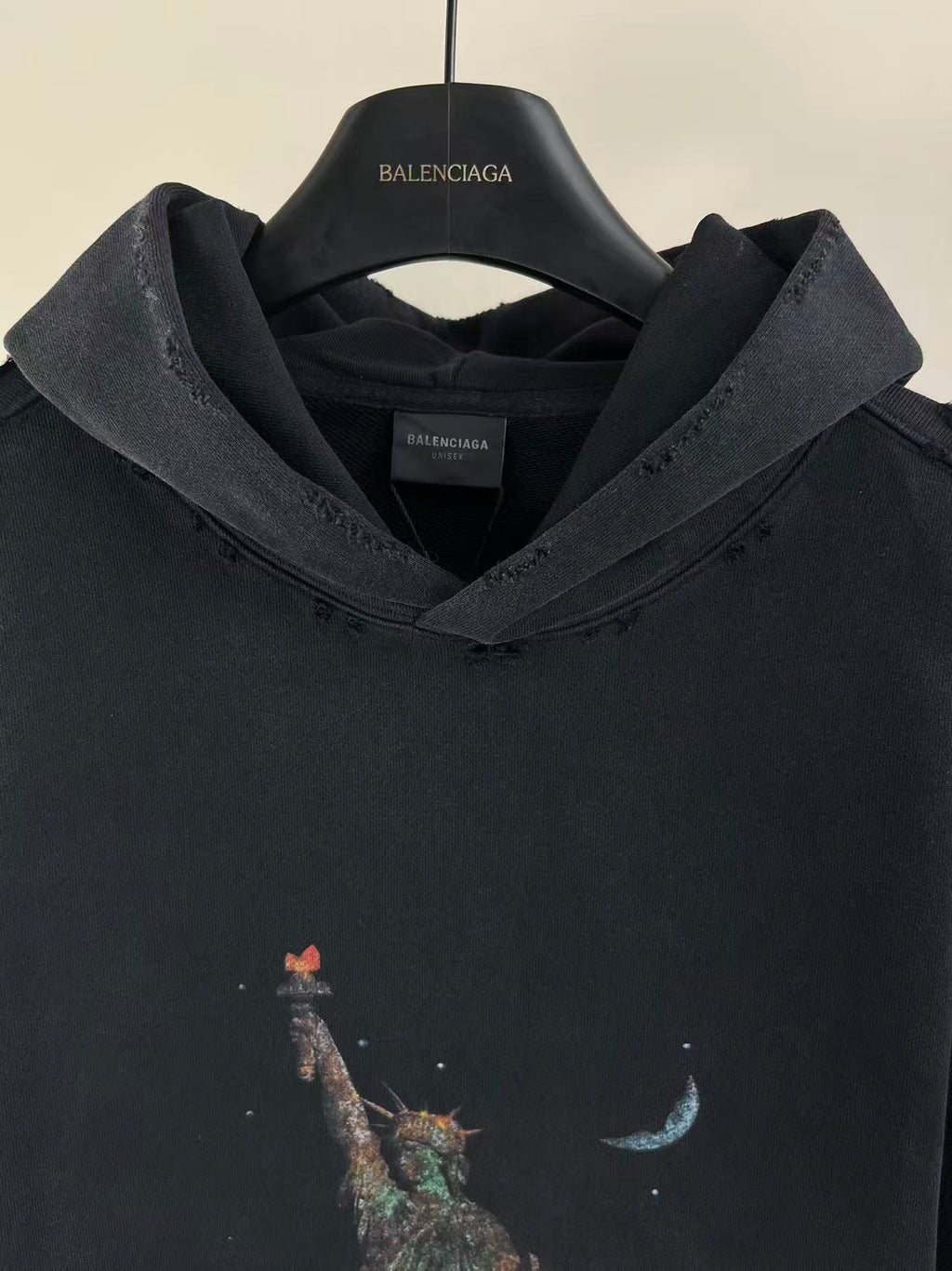 Balenciaga dark hoodie with hood, neckline detail, and multicolor animal graphic on chest
