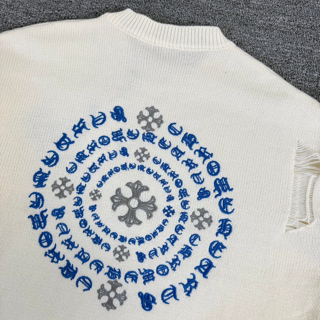 Cream knit sweater back showing blue circular motif embroidery