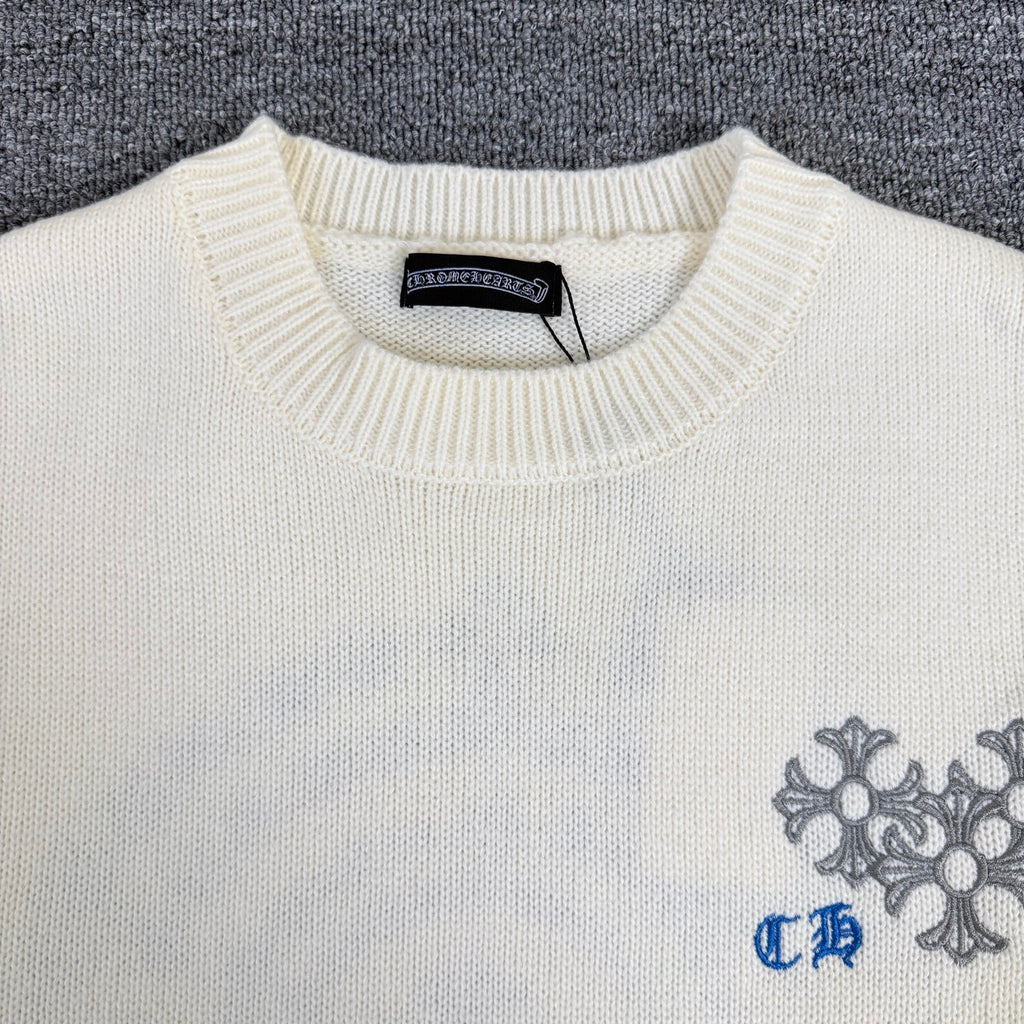 Cream knit sweater neckline with ribbed collar and brand label