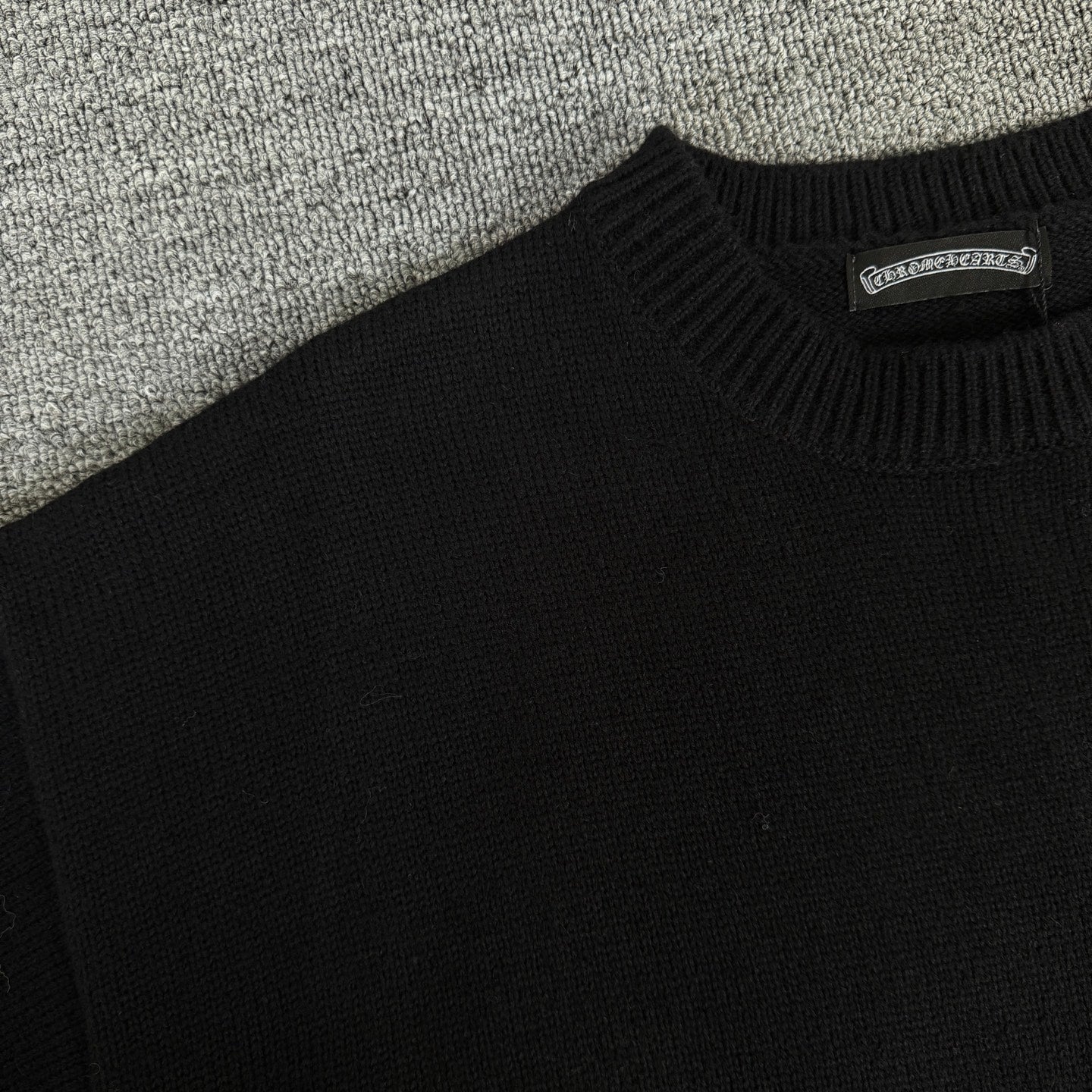 Black long-sleeve sweater knit with ribbed crew neck