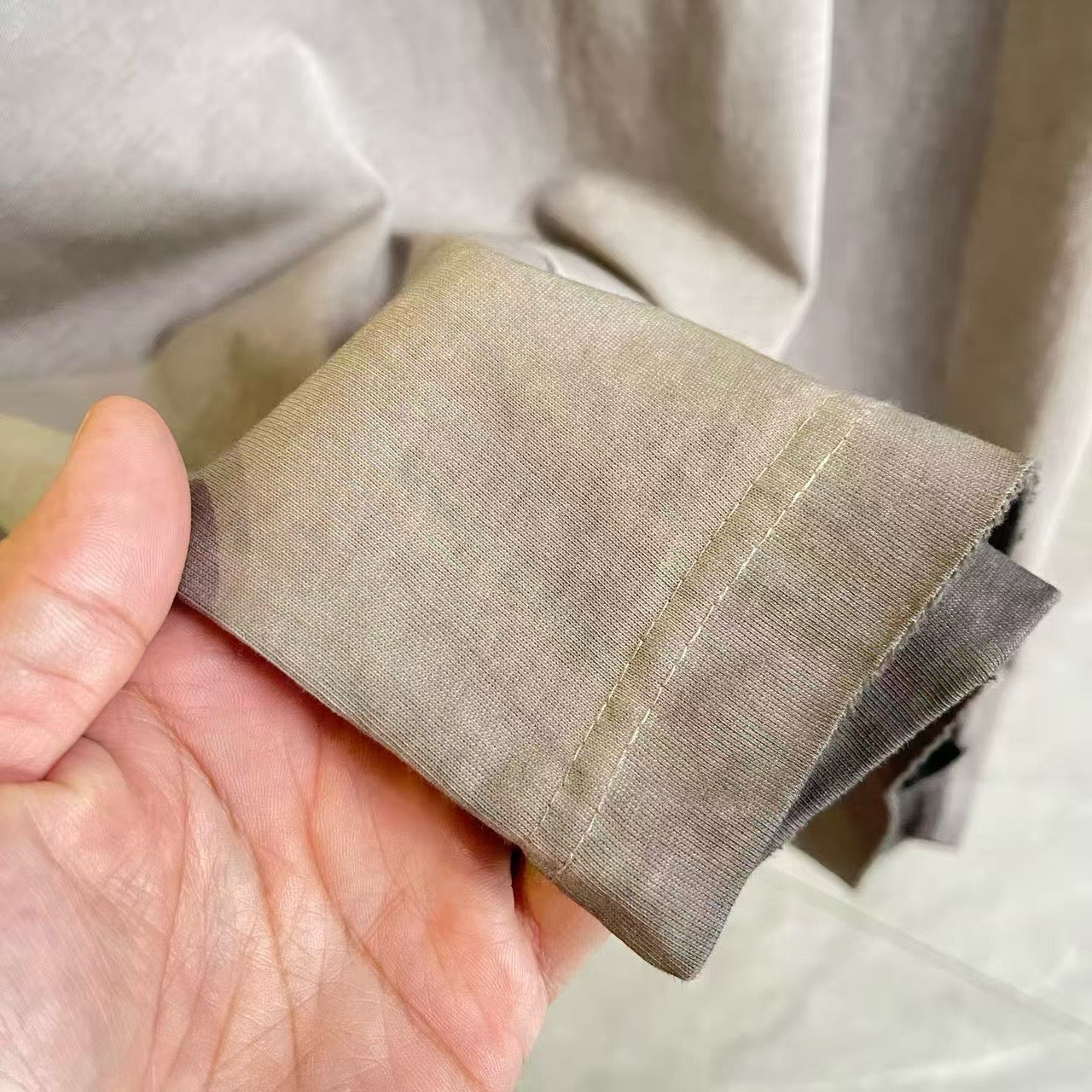 Heather gray knit T-shirt cuff and sleeve edge fabric close-up