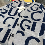 Gucci knit cardigan close-up, button placket and navy GG letters on white knit fabric