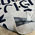 Kids cardigan hem close-up, light gray ribbed knit with navy Gucci-style stripe