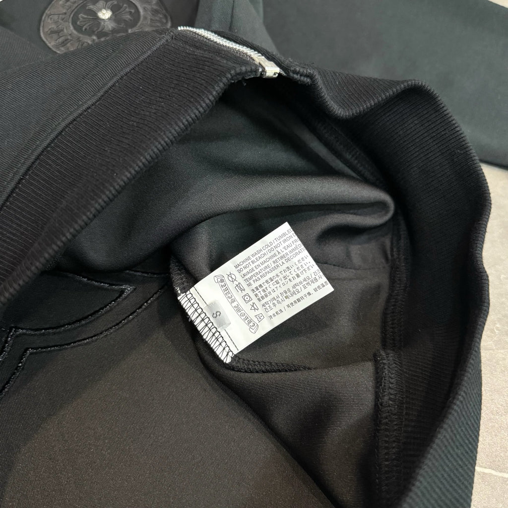 Black hoodie fabric close-up with interior care label on the collar