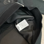 Black hoodie fabric close-up with interior care label on the collar