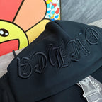 Black hoodie close-up of raised embroidered script on the hood and upper back