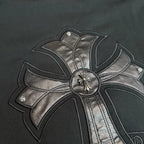 Black hoodie close-up of metallic bow center button and stitched cross details