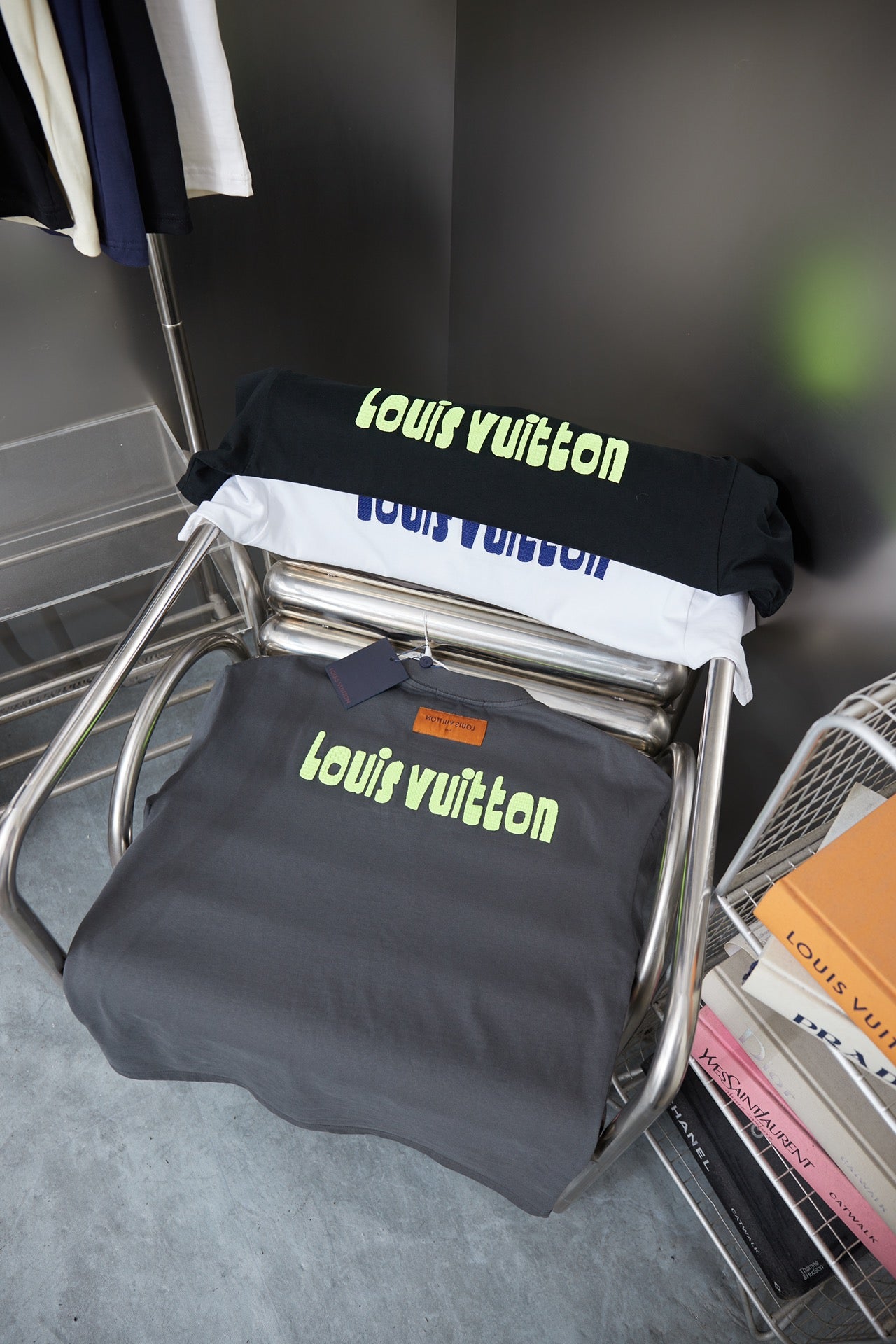 Louis Vuitton dark gray T-shirts with lime text logos on display rack