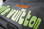 Louis Vuitton dark gray T-shirt close-up of lime 'Louis Vuitton' lettering