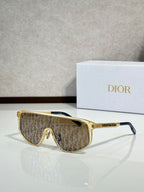 Dior sunglasses with gold frame and brown patterned tinted lenses