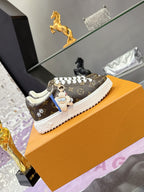 Louis Vuitton monogram sneakers with colorful charm accents and white sole.