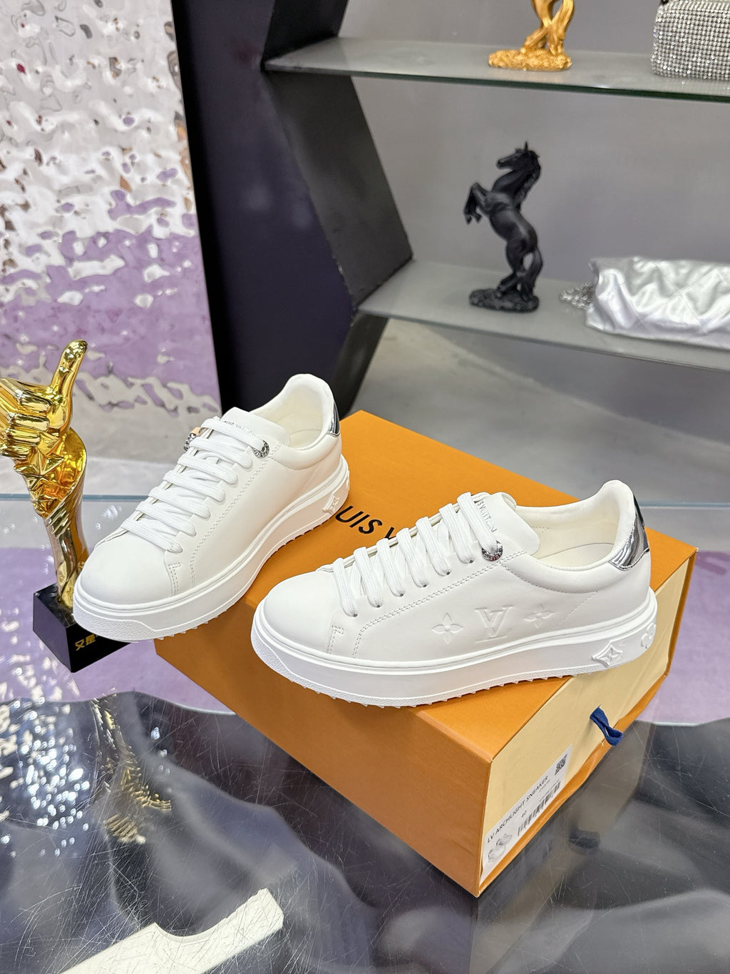 White Louis Vuitton low-top sneakers with white laces and side logo detail