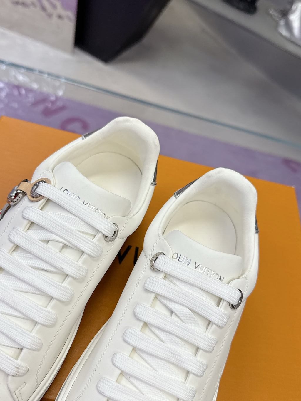 White Louis Vuitton sneakers, front view pair with lace-up closure and padded collar