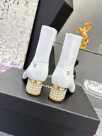 White mid-calf boots with gold jeweled block heels and gold zipper pulls