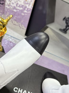 White boot upper with black toe cap and gold ankle seam detail