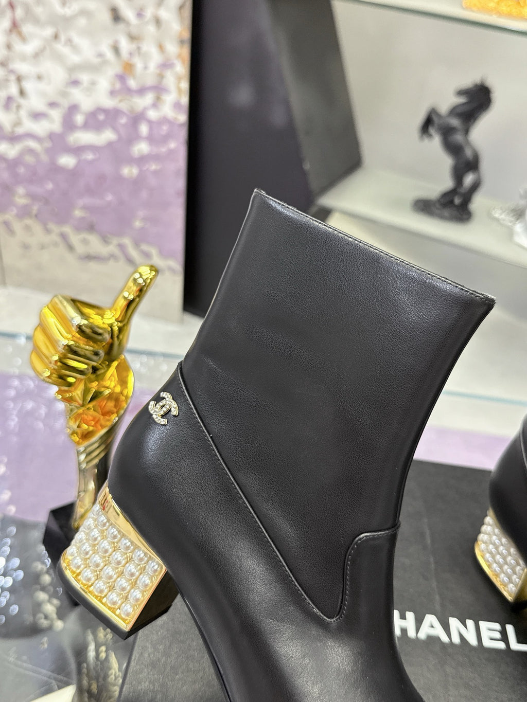Black leather ankle boot with side logo and pointed seam panel