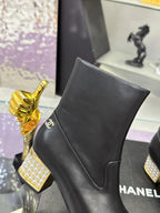 Black leather ankle boot with side logo and pointed seam panel