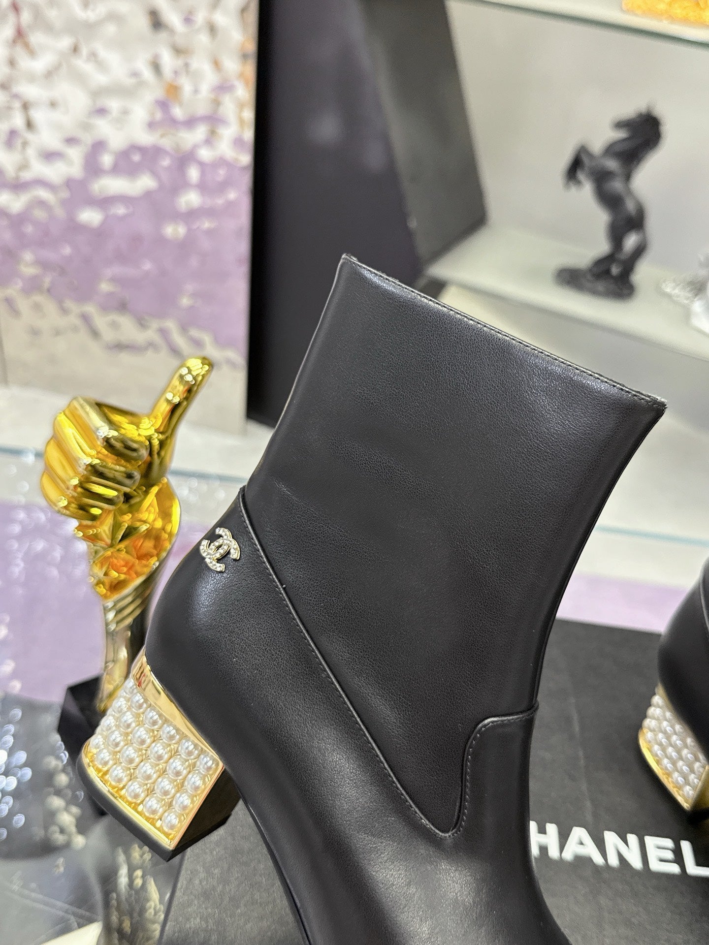 Black leather ankle boot with side logo and pointed seam panel