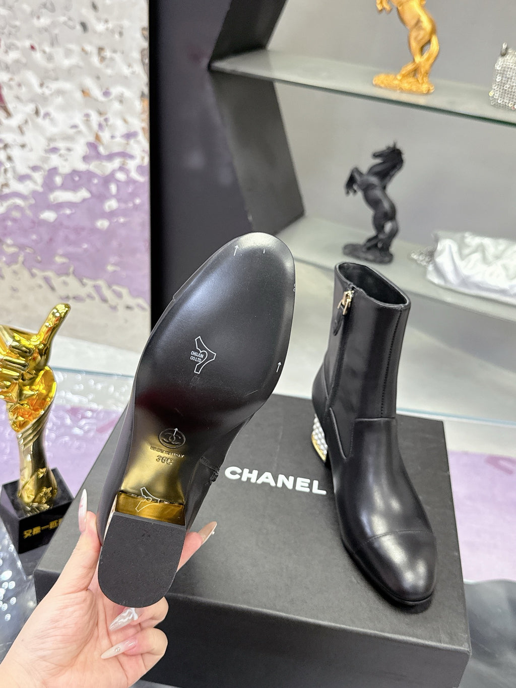 Black leather boot sole and side view with CHANEL logo on heel