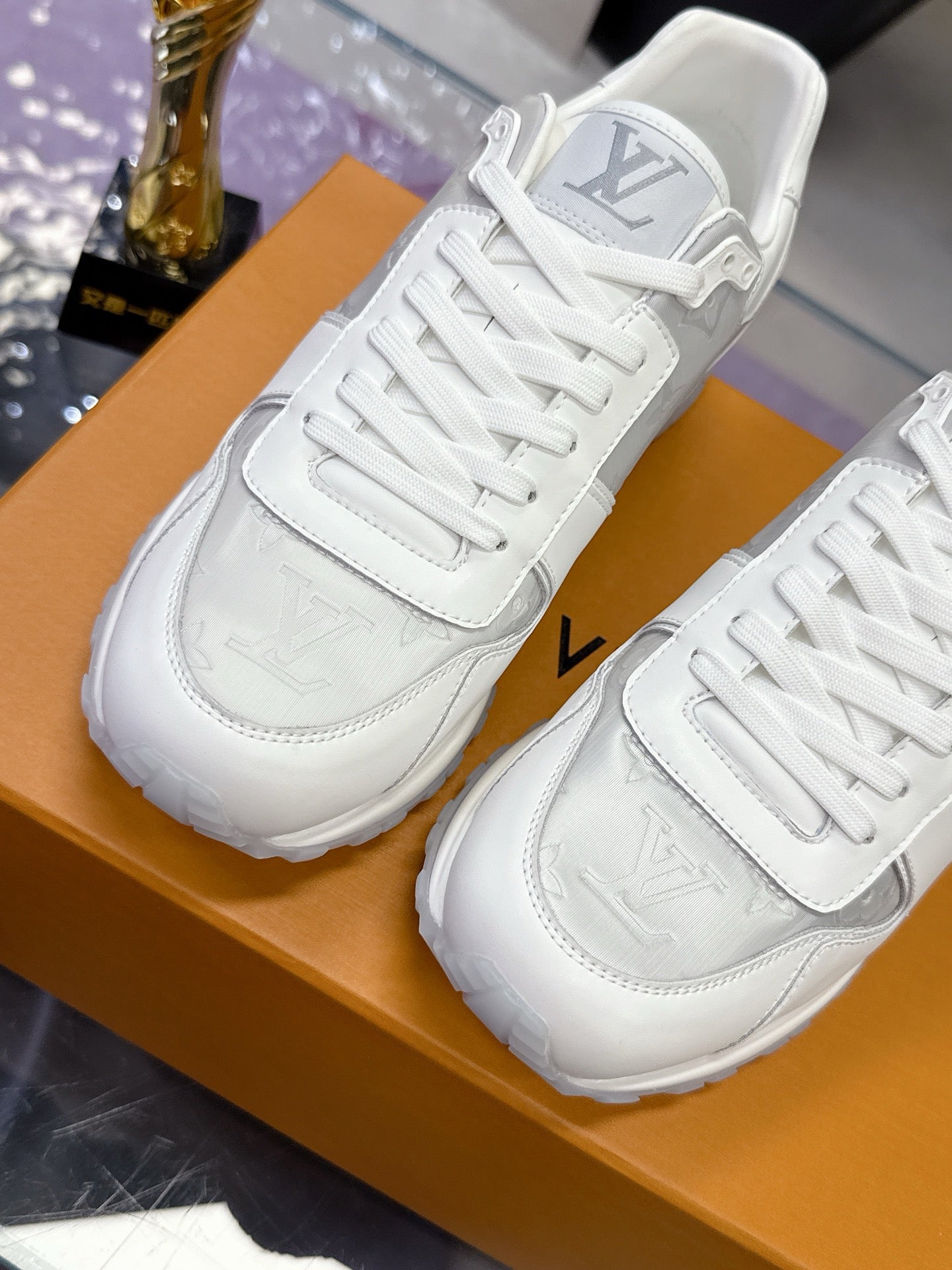 Louis Vuitton ladies white sneakers with LV logo on heel and side, lace-up design