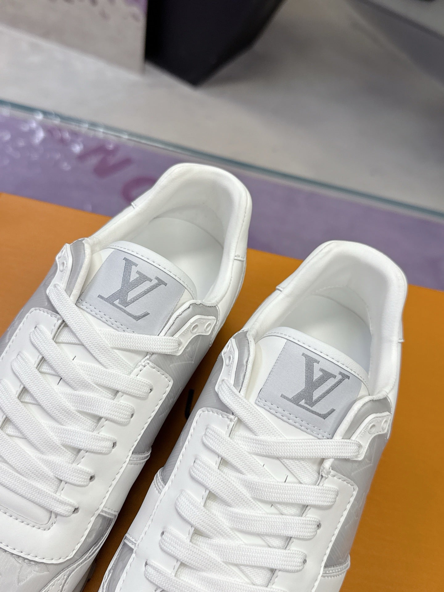 Louis Vuitton ladies white sneakers close-up, laces and tongue label with LV logo