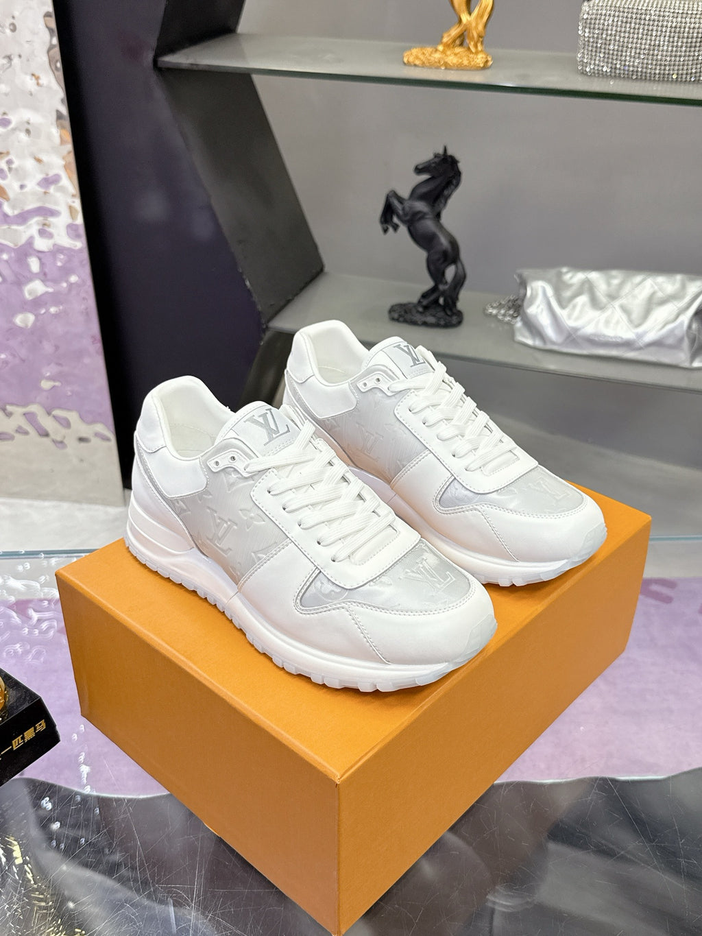 Louis Vuitton ladies white sneakers on orange box, lace-up with side logo panel