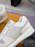 Louis Vuitton ladies white leather sneaker close-up with side panel LV emblem and laces