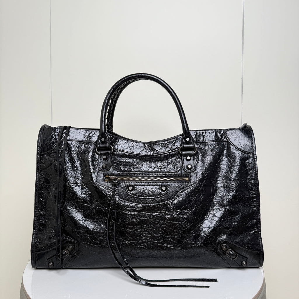 Balenciaga black leather tote bag with top handles, front zipper pocket and studded sides