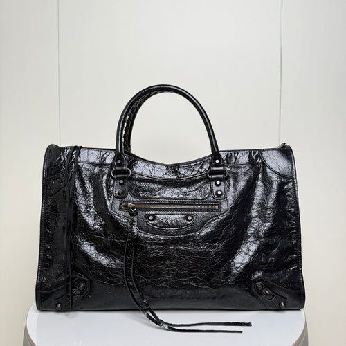 Balenciaga black leather tote bag with top handles, front zipper pocket and studded sides