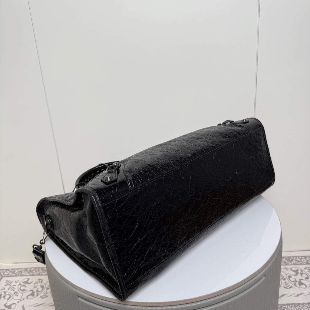 Balenciaga black leather tote bag with wide strap and structured end panel