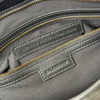 Balenciaga embossed leather logo patch on interior pocket with gold zipper trim