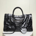 Balenciaga black leather tote bag with top handles and front zipper pocket plus heart charm