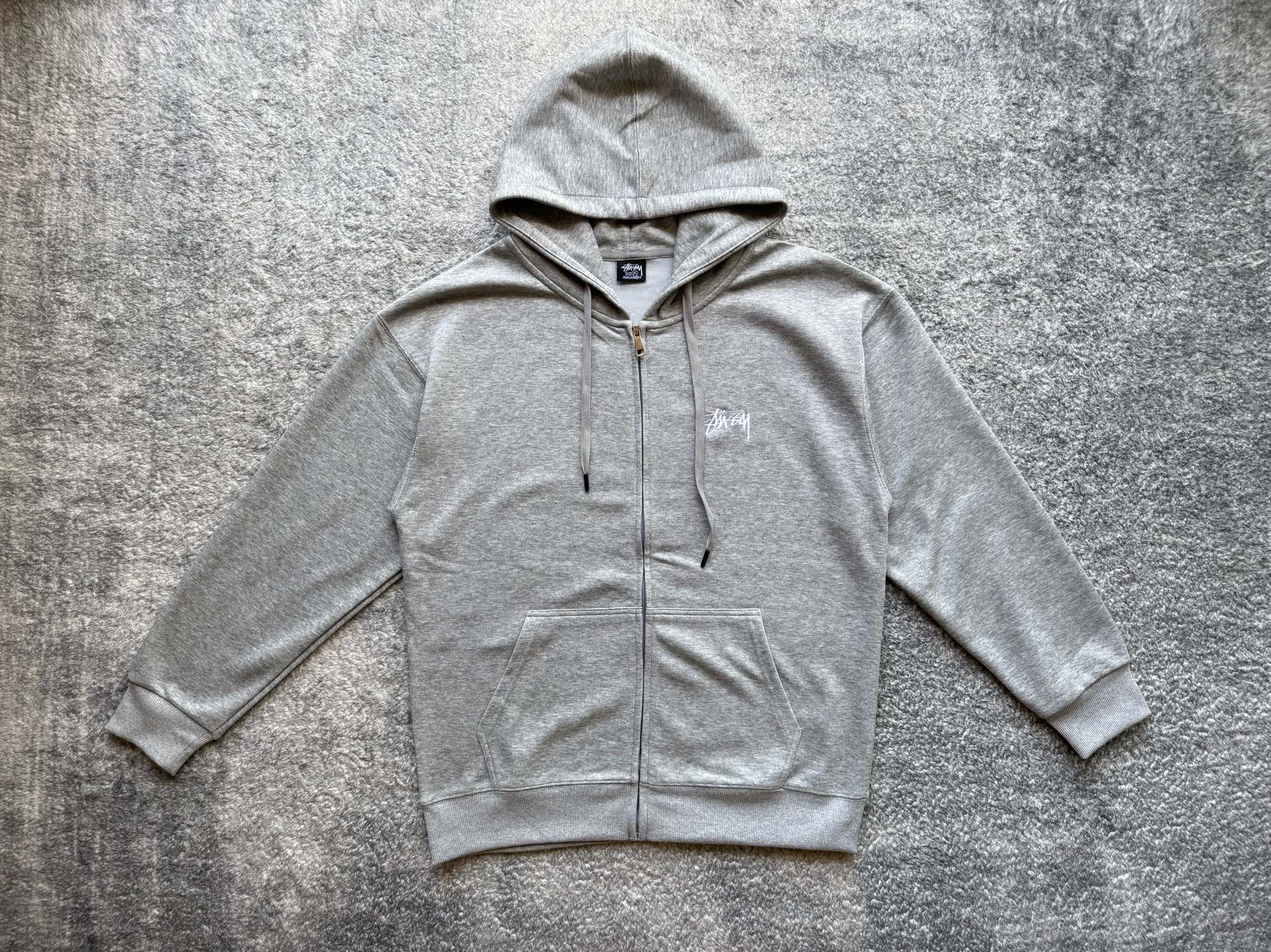 Stussy heather gray zip hoodie with drawstring hood and small chest logo