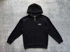 Stussy black zip-up hoodie front with drawstring hood and chest logo