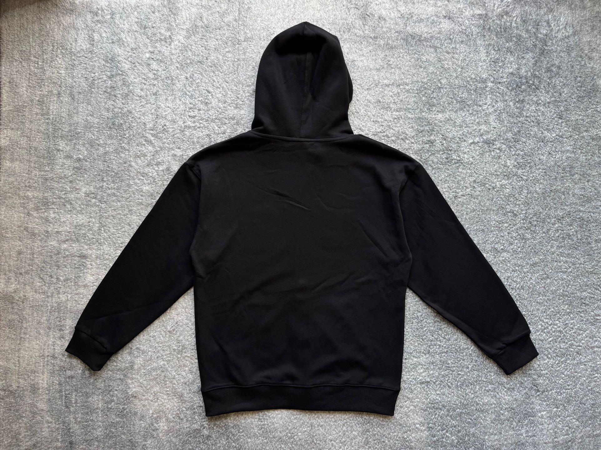 Stussy black zip-up hoodie back with drawstring hood and ribbed hem cuffs