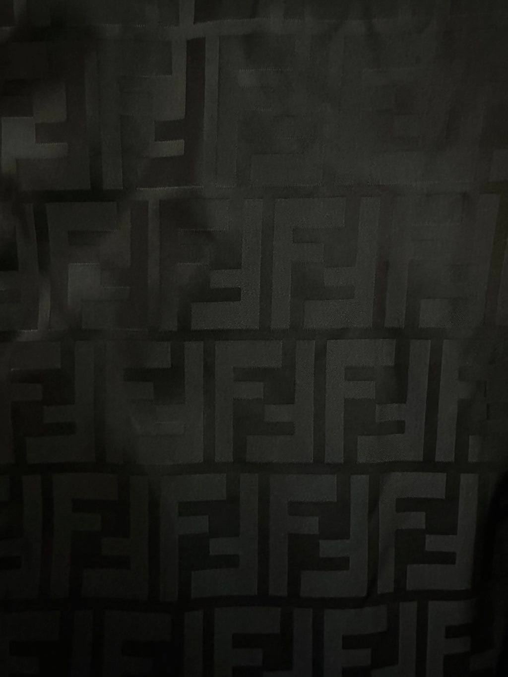 Black jacquard fabric with repeating FENDI monogram pattern
