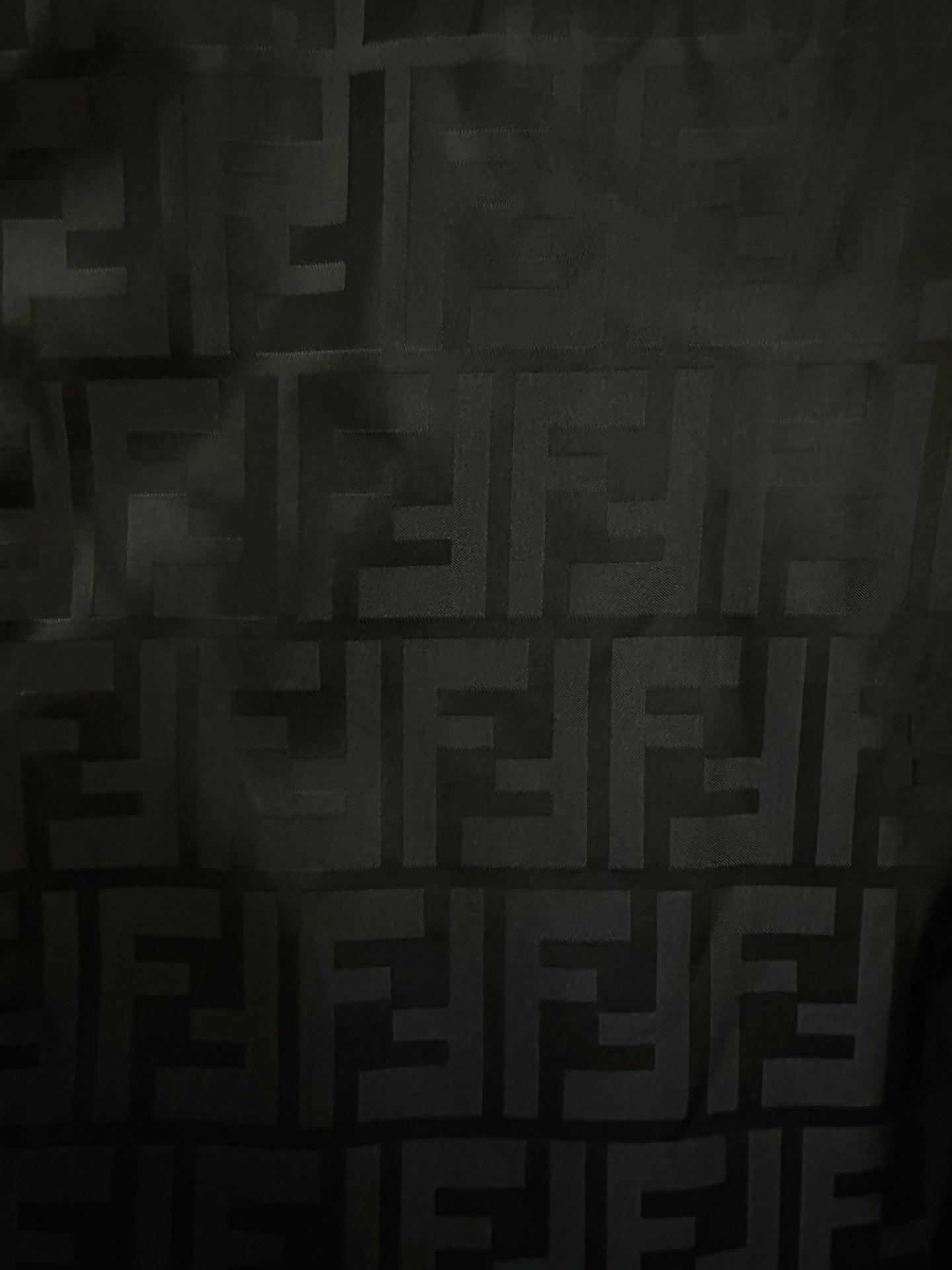 Black jacquard fabric with repeating FENDI monogram pattern