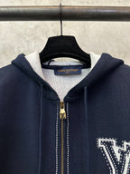Navy Louis Vuitton zip-up hoodie neckline with gold zipper pull and LV lettering