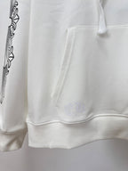 White hoodie cuffs and hem with small chest emblem near pocket