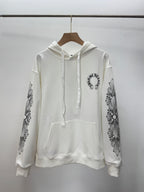 White pullover hoodie with hood and drawstring; front pocket; printed sleeve graphics