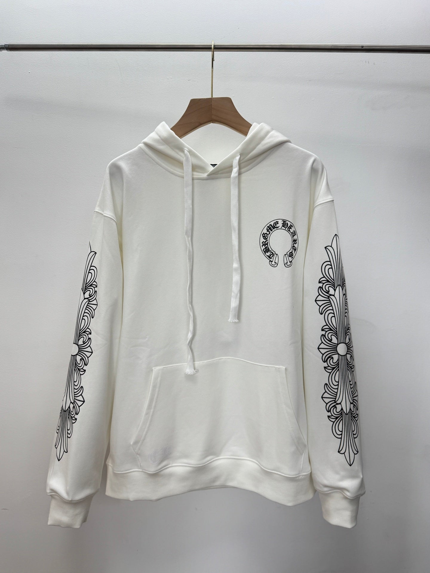 White pullover hoodie with hood and drawstring; front pocket; printed sleeve graphics