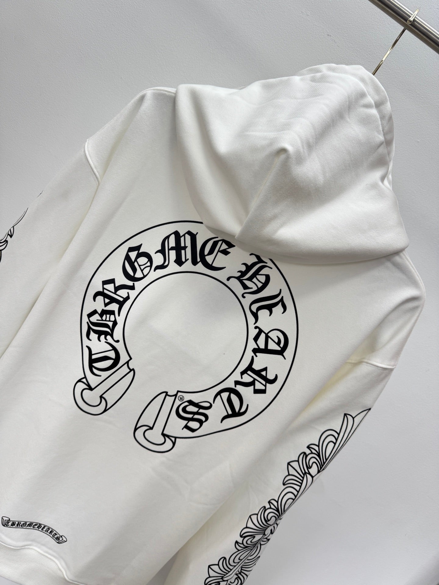 White hoodie back with large circular logo graphic and small text label