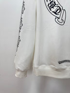 White hoodie side view with printed sleeve border and small logo near hem
