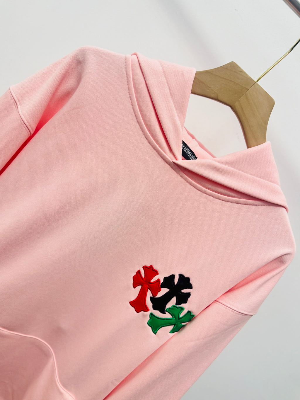 Pink hoodie neckline with hood and small multicolor floral chest embroidery
