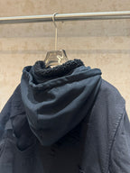 Balenciaga long hooded jacket back view, dark with shearling-lined hood