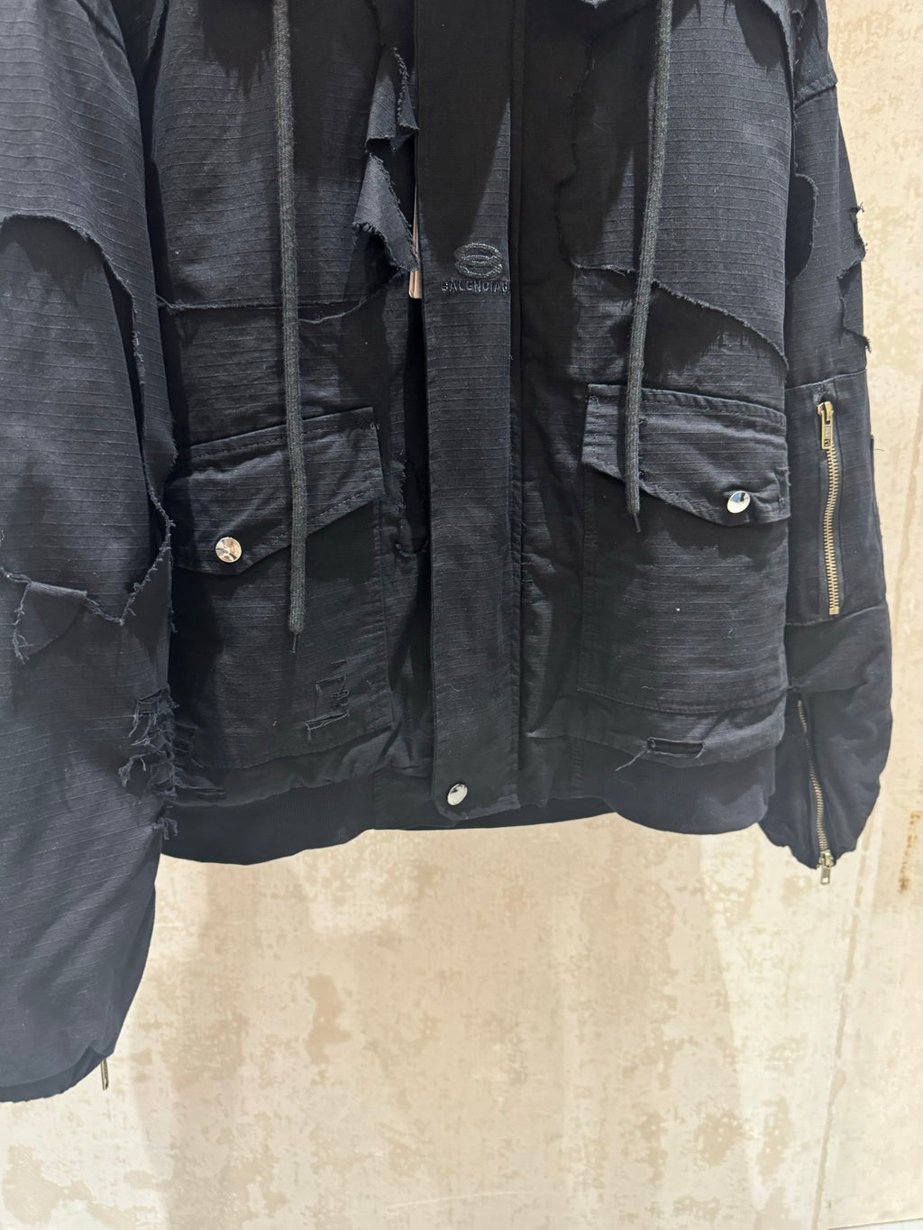 Balenciaga long jacket detail, dark with flap chest pockets and zipper trim