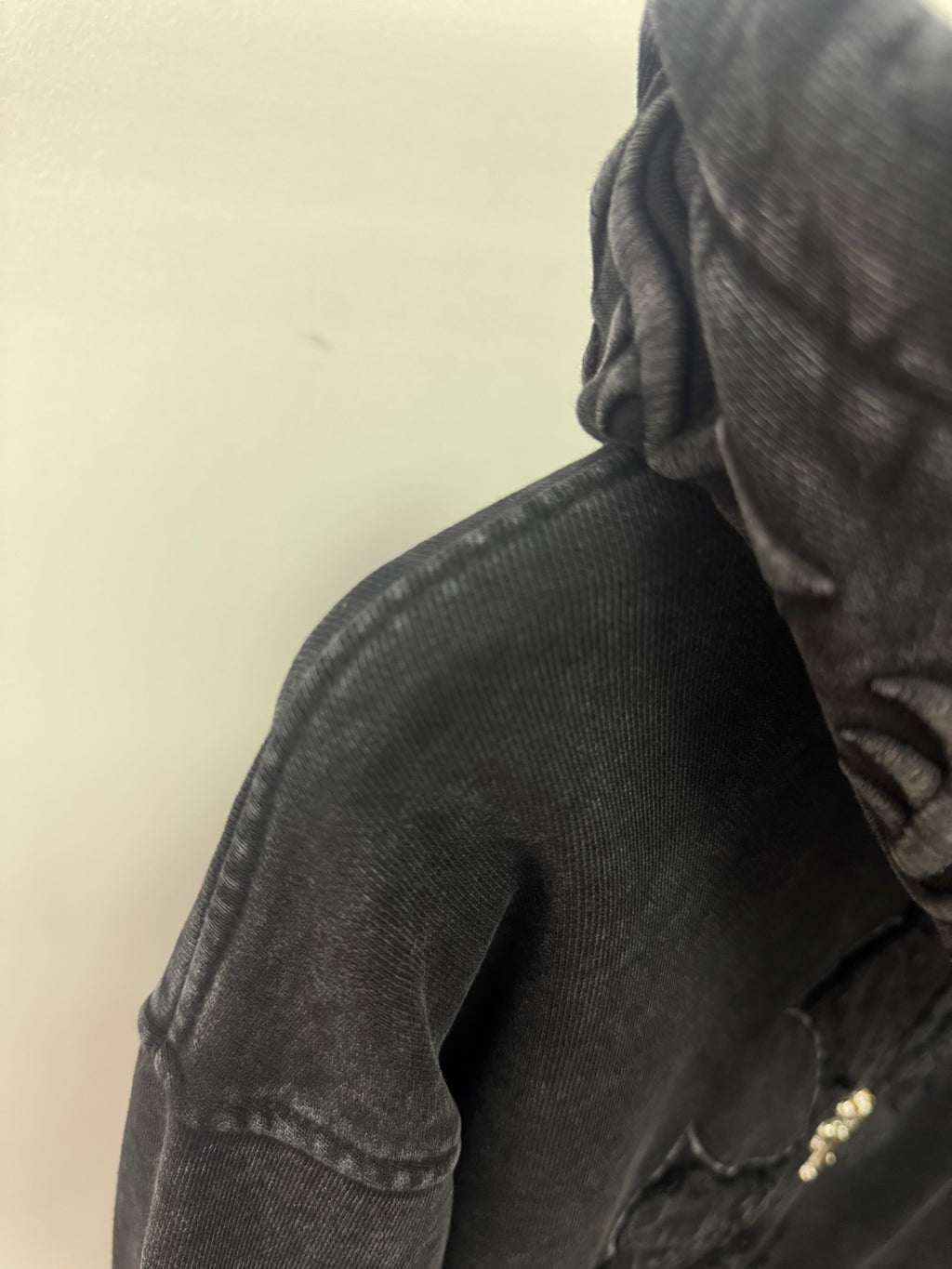 Dark long-sleeve hooded top with textured fabric